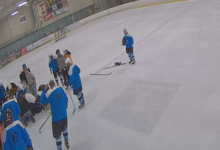 Bystanders performing CPR and using an AED after a hockey player collapses from sudden cardiac arrest