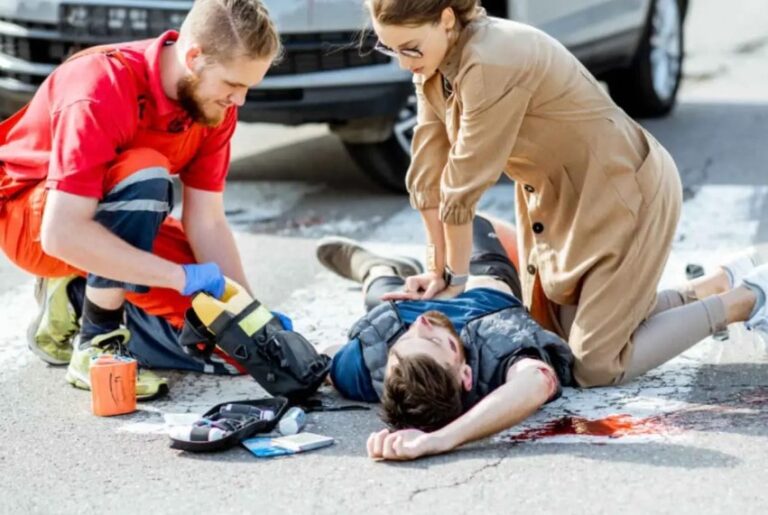 Bystanders performing CPR on a motorcyclist after a fatal crash at Norseman Street and Islington Avenue in Etobicoke