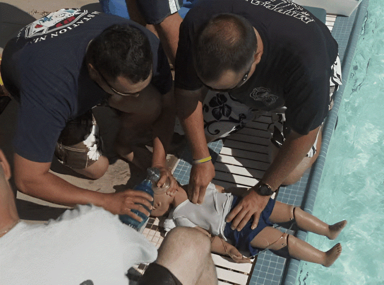 Bystanders performing CPR on a young child after a backyard pool incident in Surrey, British Columbia