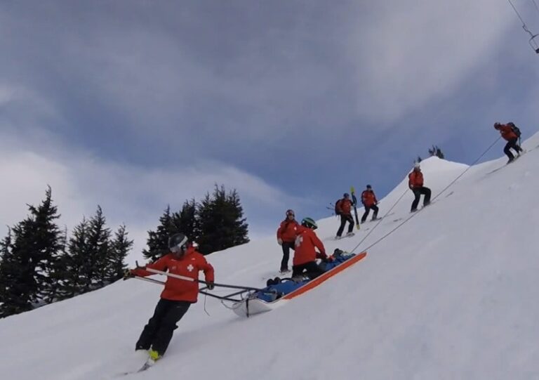 Ski patrol performing CPR on unresponsive snowboarder at Whistler Blackcomb after serious mountain accident
