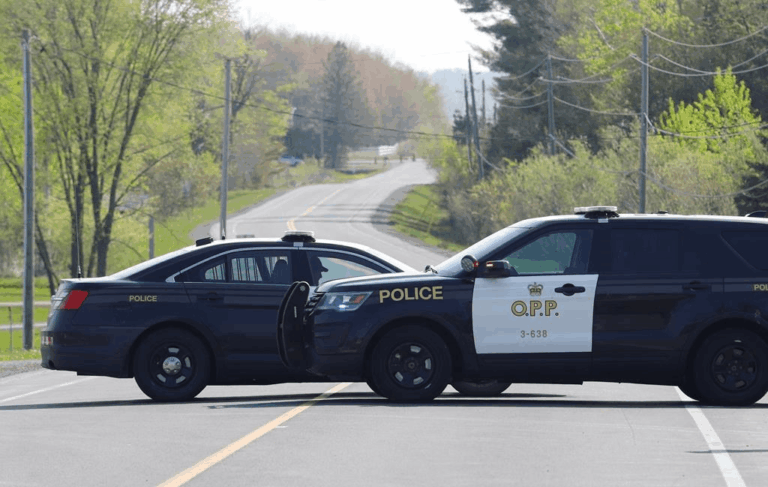 Ontario Provincial Police vehicles blocking a rural road during an emergency response near Morrisburg, Ontario