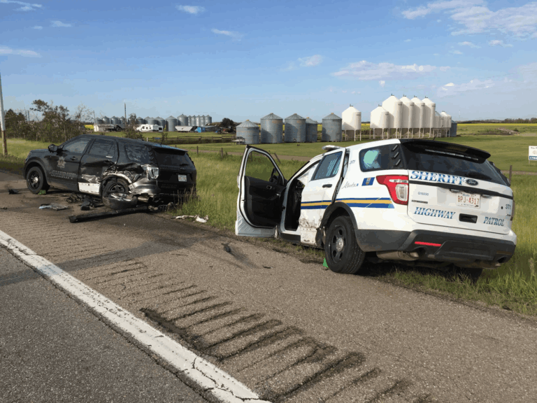 Police vehicles damaged during a Central Alberta highway incident, highlighting the need for first aid and CPR training.