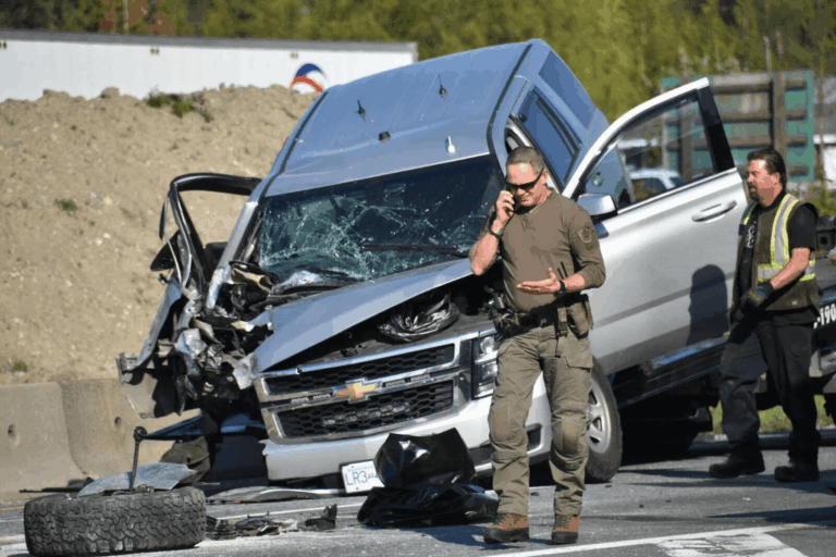 RCMP officer responding at the scene of a highway collision involving a damaged pickup truck during an emergency situation