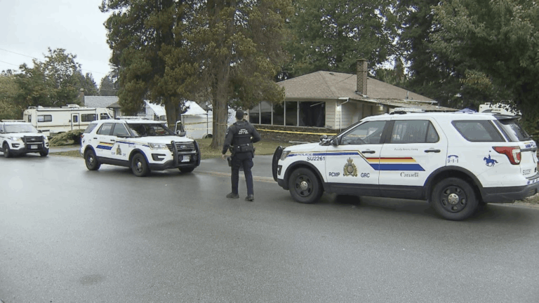 Surrey RCMP officers securing a crime scene following a fatal shooting outside a Surrey hotel in British Columbia