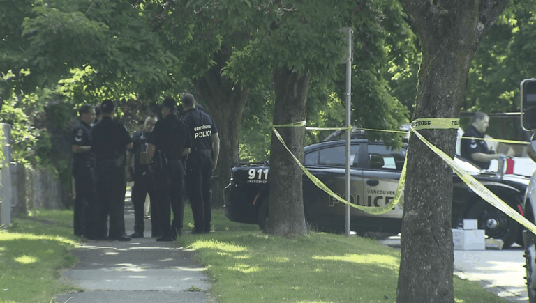 Vancouver police officers at a taped-off crime scene following a shooting incident