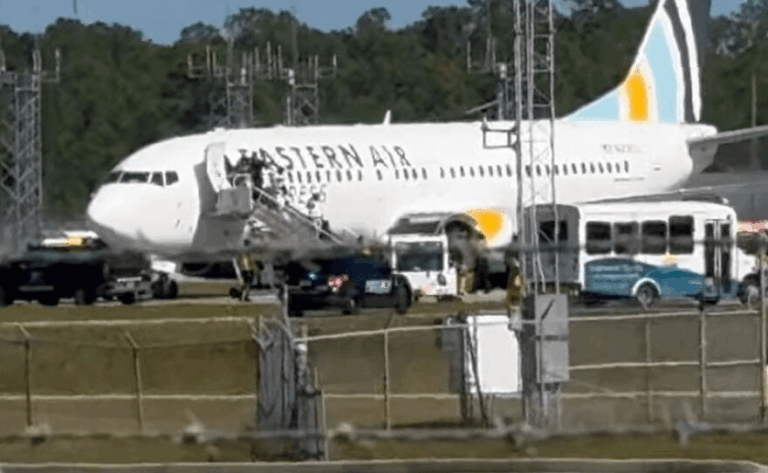 Commercial passenger aircraft parked at a small island airport in Cuba during flight delays following runway damage