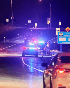 Police vehicles with flashing lights at night as officers respond to a serious emergency incident