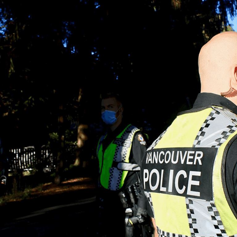 Vancouver police officers at an active investigation scene during a serious incident in a residential area