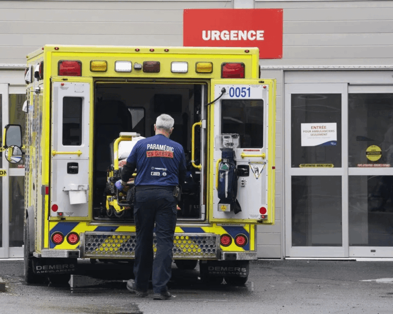 Paramedics load a patient into an ambulance after a cardiac arrest emergency at a Canadian hospital.