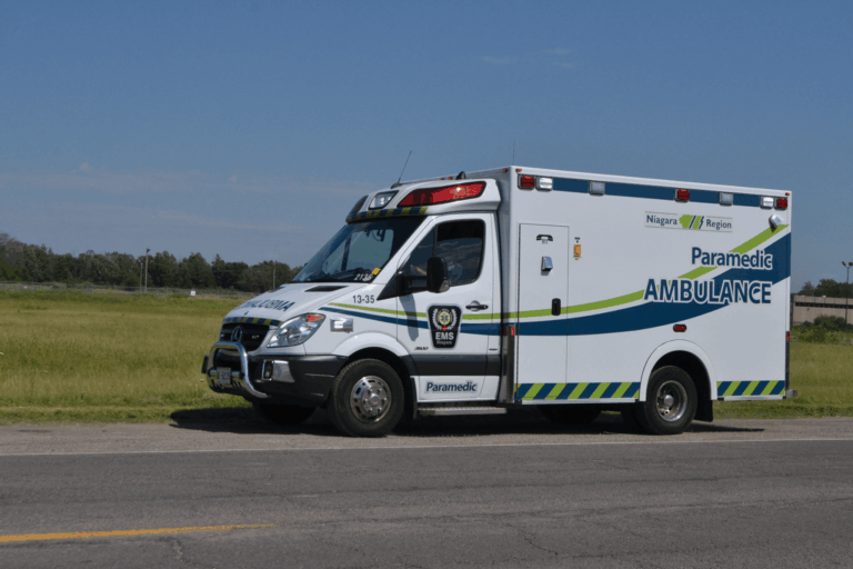 Ambulance responding to a medical emergency in a rural area, highlighting the importance of CPR and emergency services.