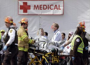 Bystanders performing CPR on a collapsed runner during a public marathon event