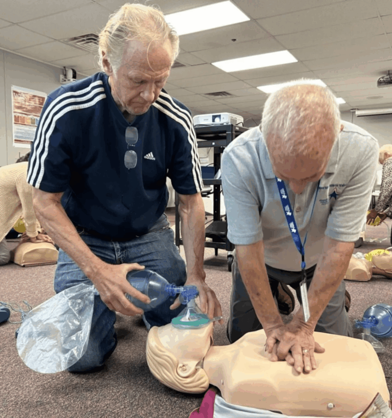 Bystanders practicing CPR and rescue breathing during a hands-on first aid training session