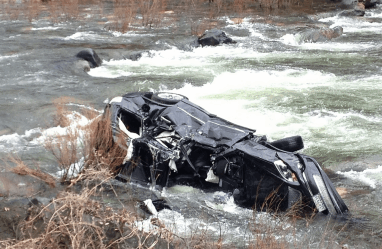 Car overturned and partially submerged in a fast-moving river following a fatal crash near Montreal